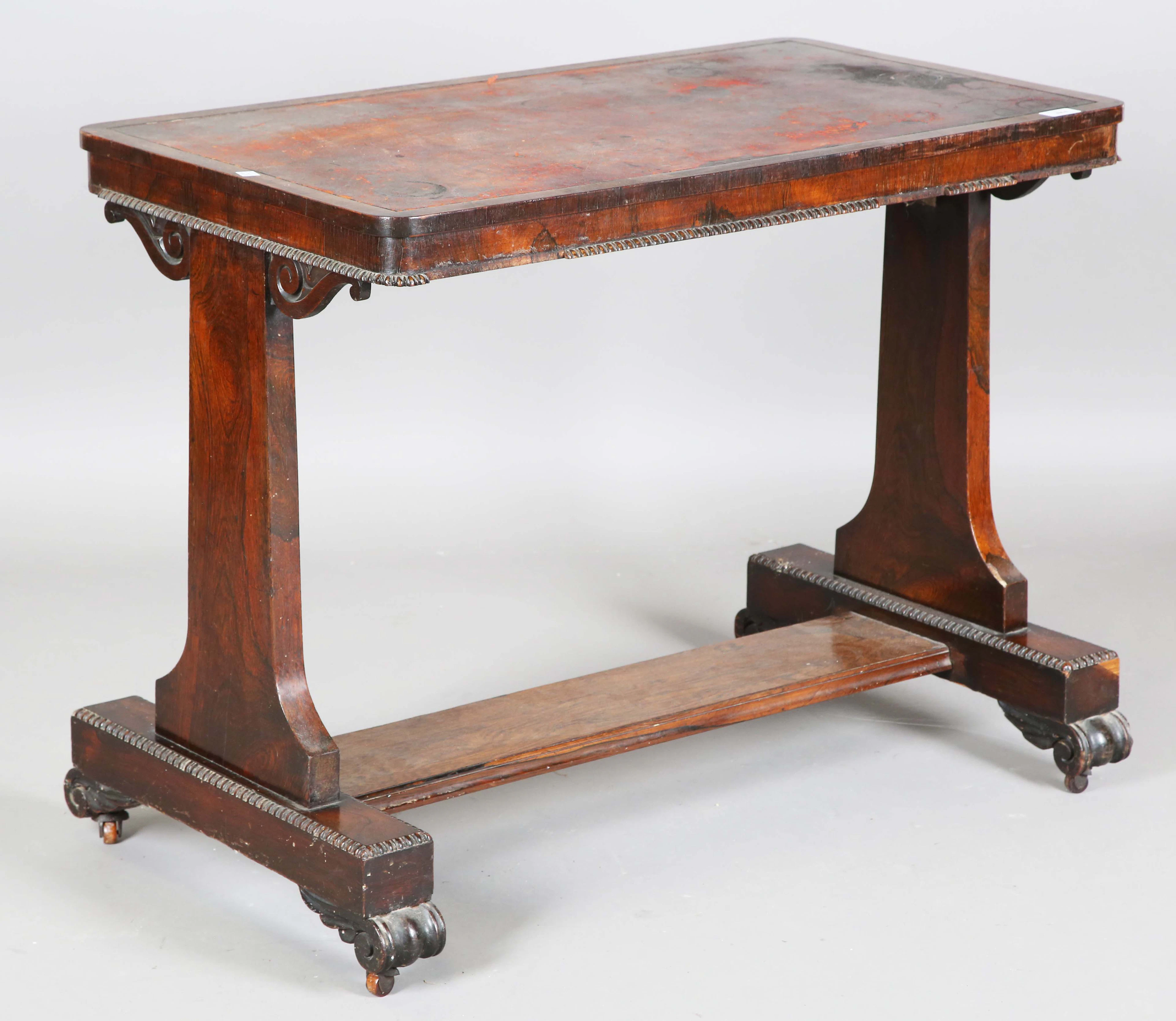 A Regency rosewood writing table, the top inset with red leather