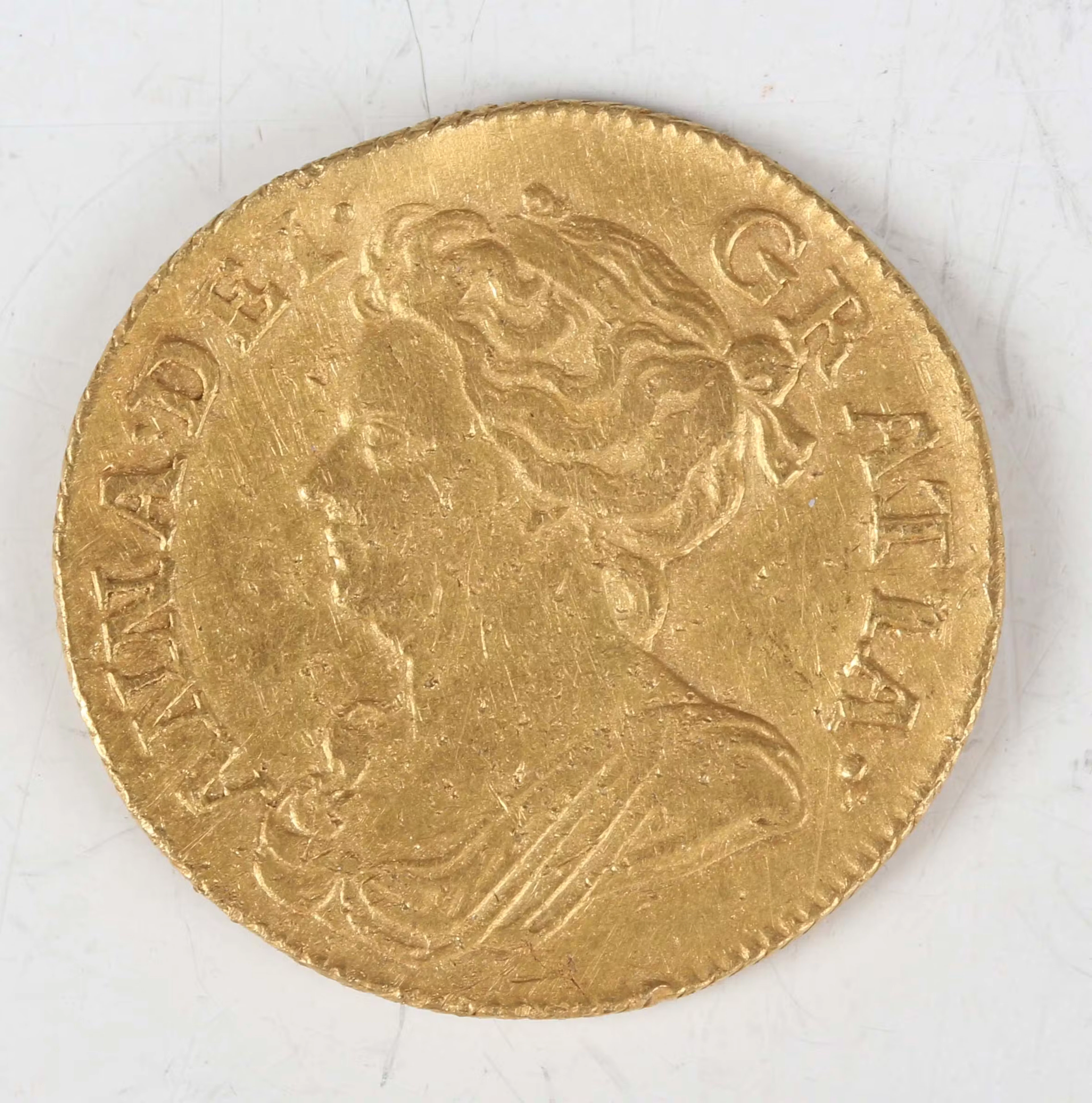 An Anne guinea 1714, third draped bust, Sp 3574 (overall poor, excavated