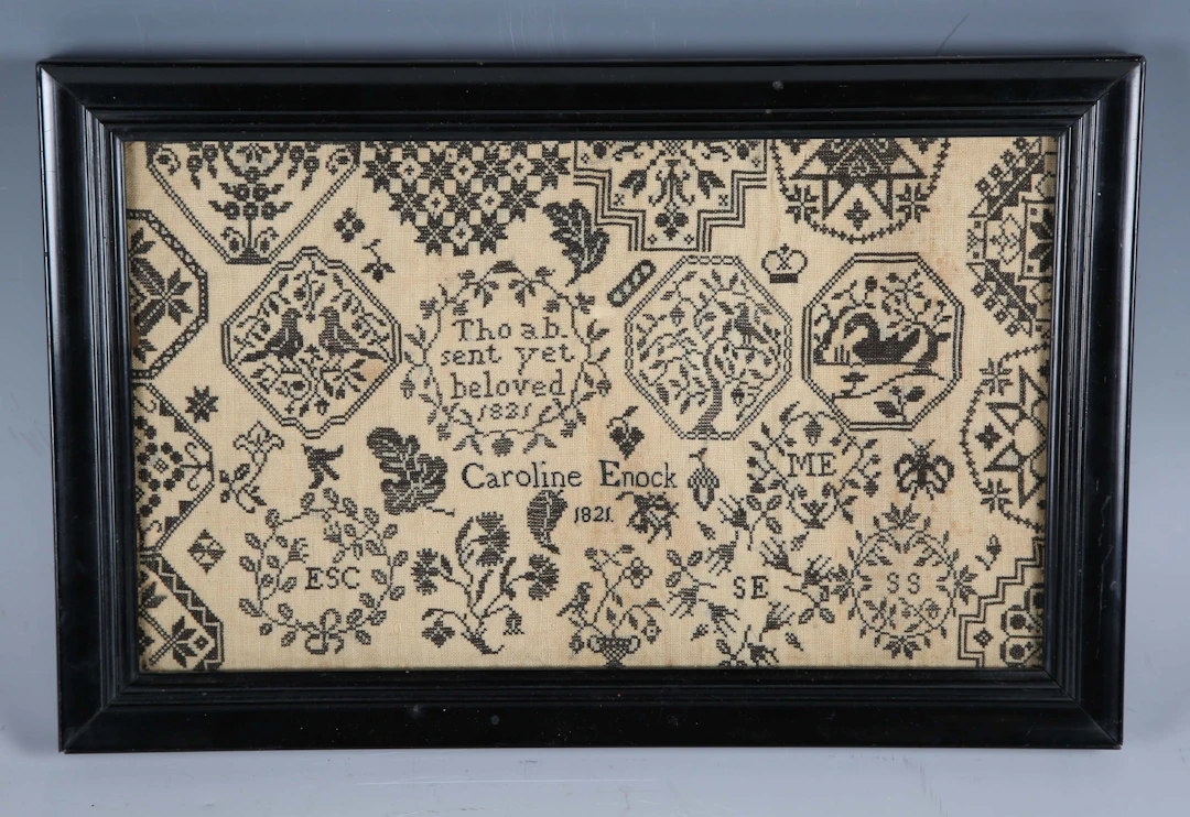 A Regency monochrome needlework sampler by Caroline Enock, dated 1821