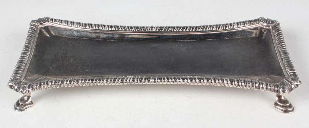 A George III silver snuffer tray of waisted rectangular form with