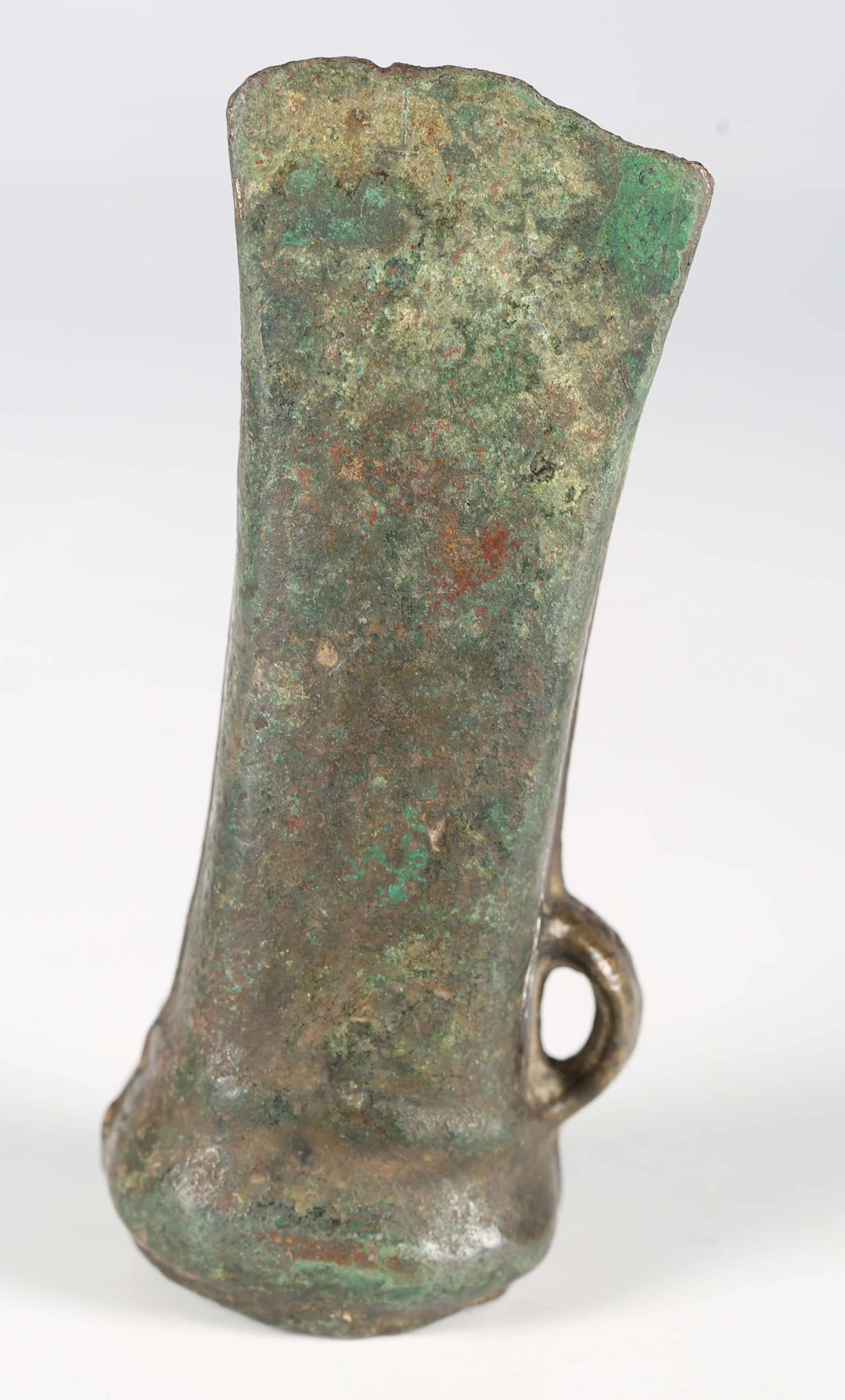 A European Bronze Age socketed axe head with overall green patinated