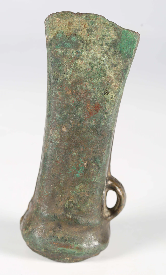 A European Bronze Age socketed axe head with overall green patinated