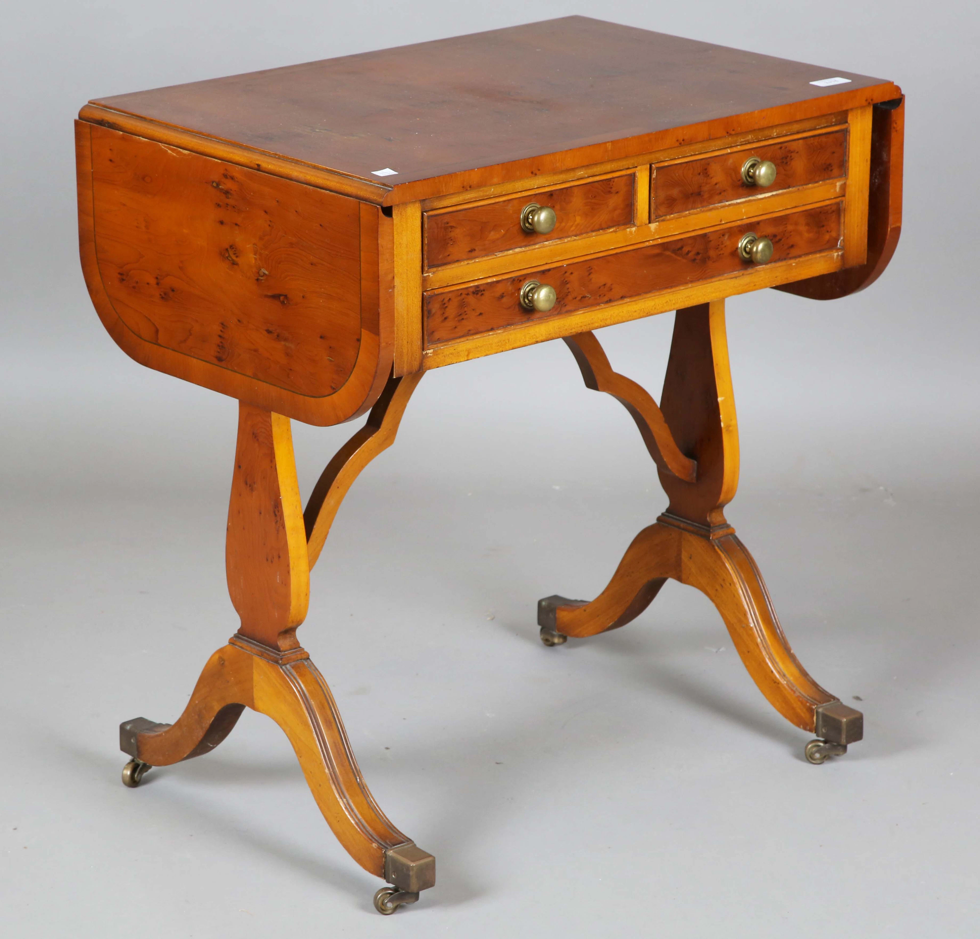 A late 20th century yew wood reproduction sofa table, height 71cm