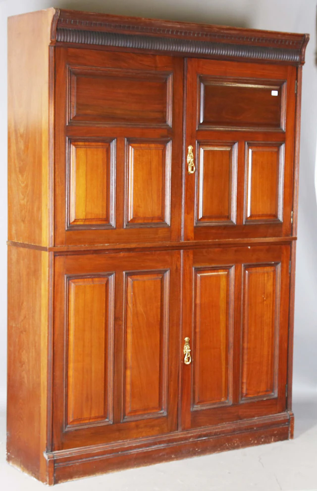 An Edwardian walnut housekeeper's cupboard, fitted with four fielded