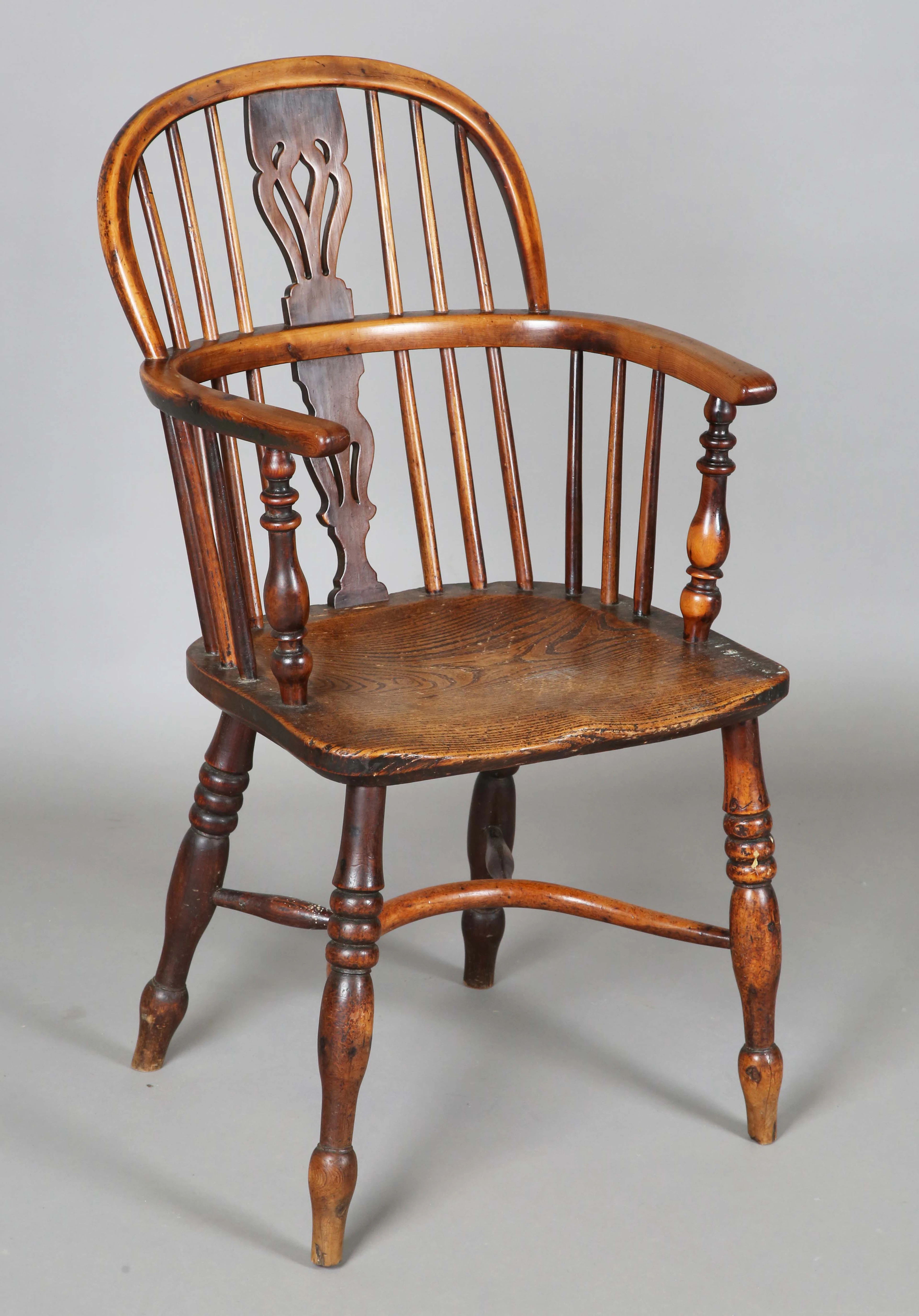 An early Victorian yew wood and elm pierced splat back Windsor armchair