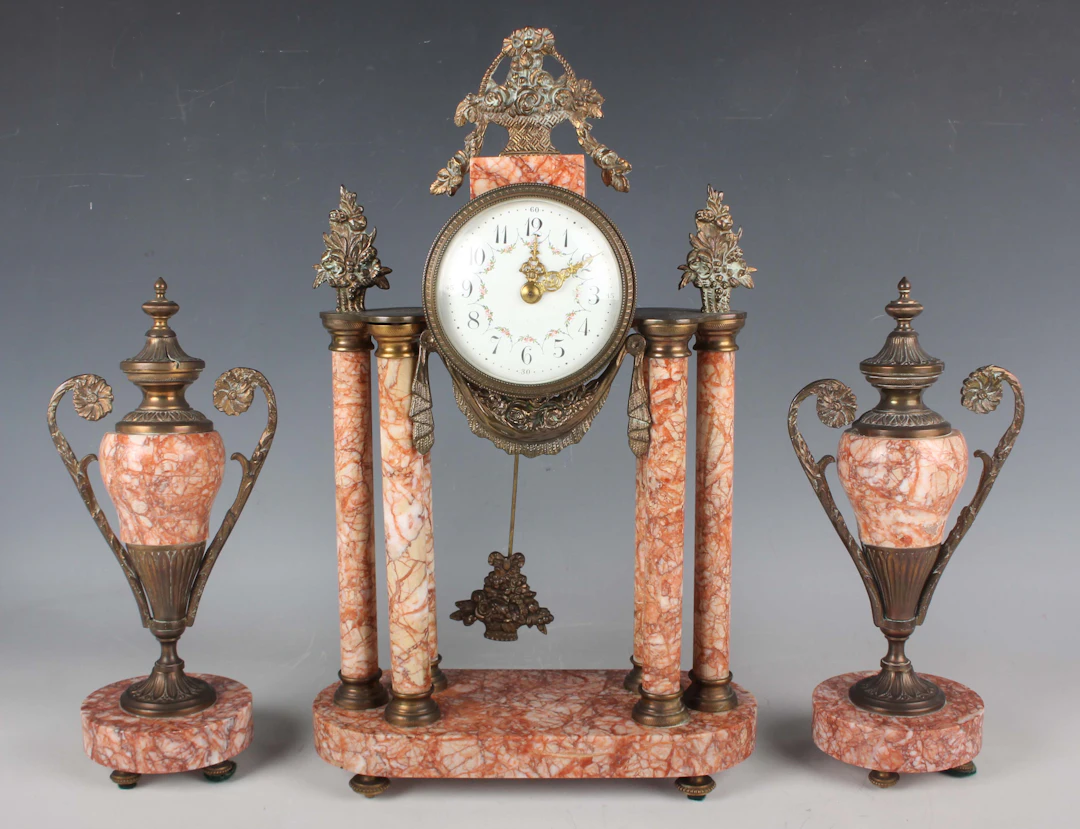 An early 20th century French rouge marble and gilt metal mounted clock