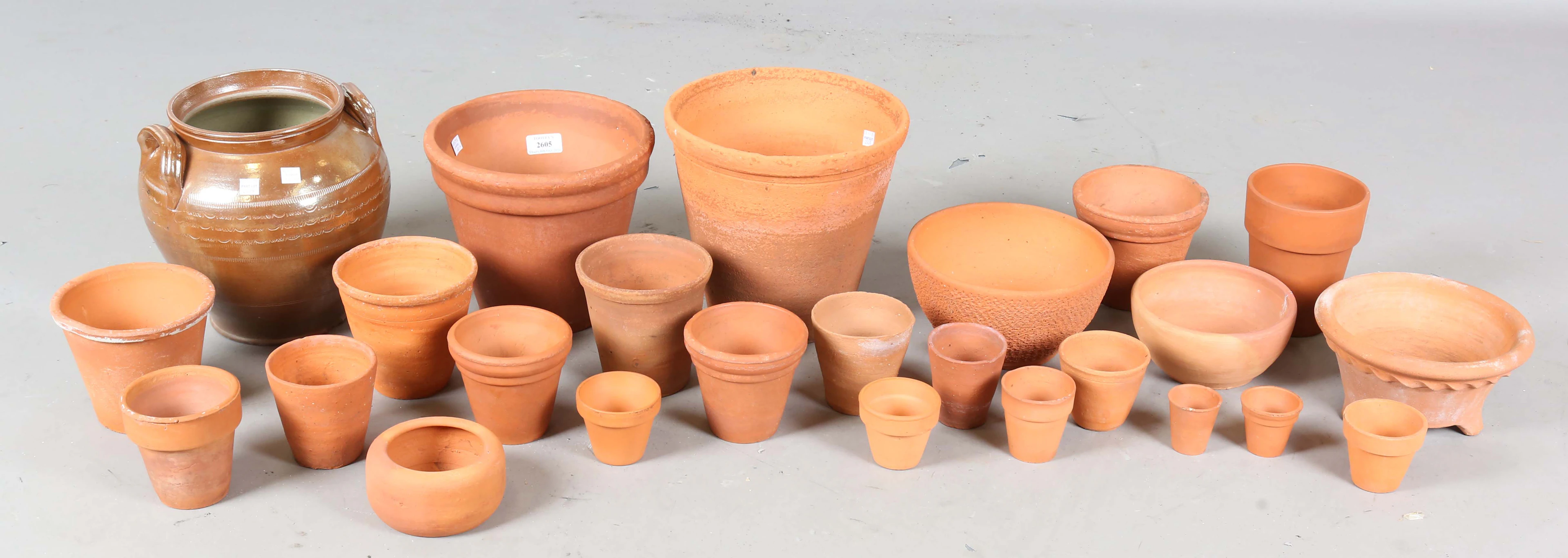 A group of terracotta garden pots and a saltglazed stoneware kitchen