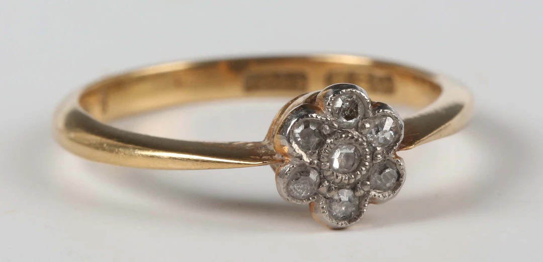 A gold and diamond ring, mounted with seven single cut diamonds in