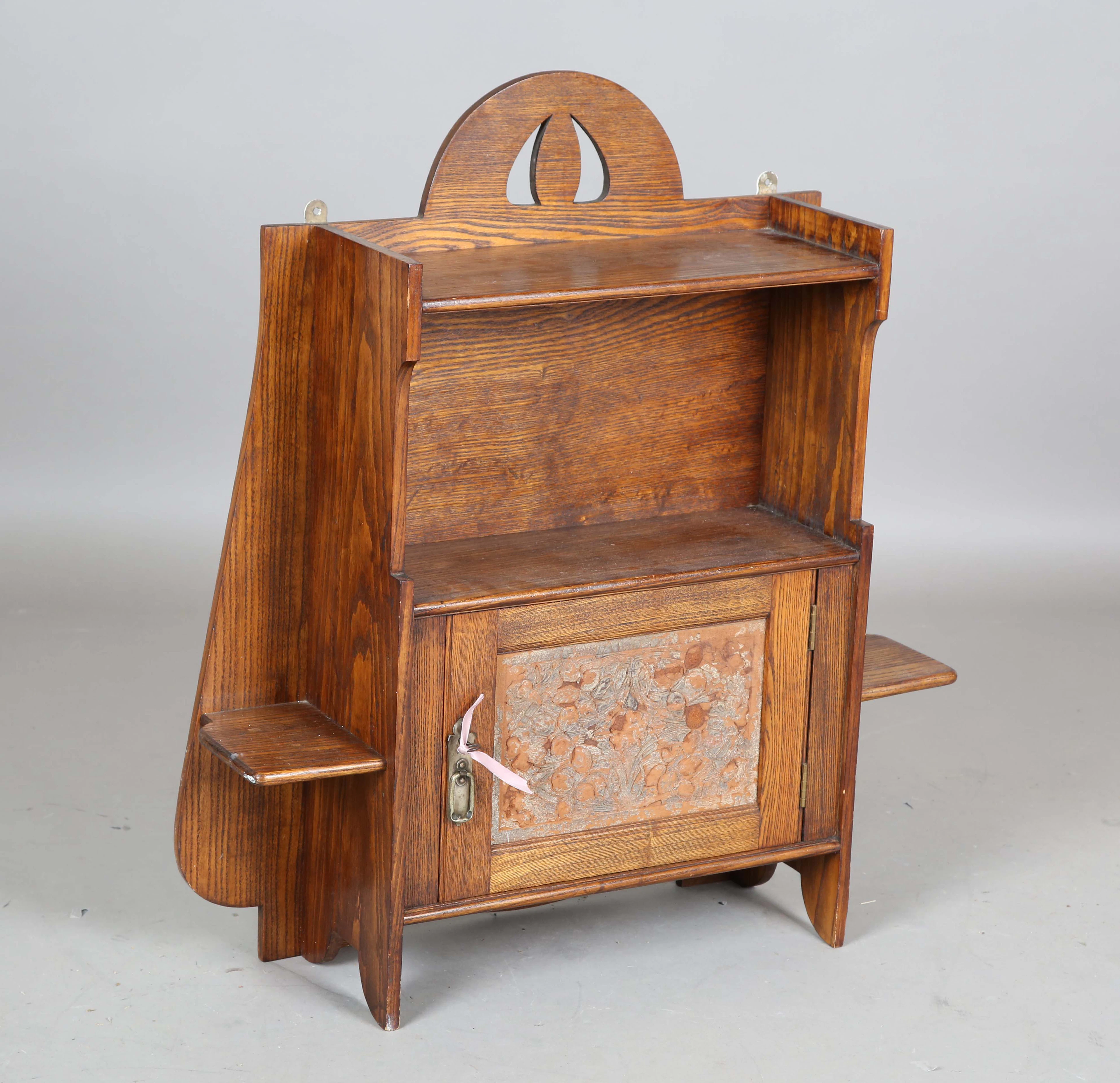 An Edwardian Arts and Crafts oak hanging wall cabinet, possibly by