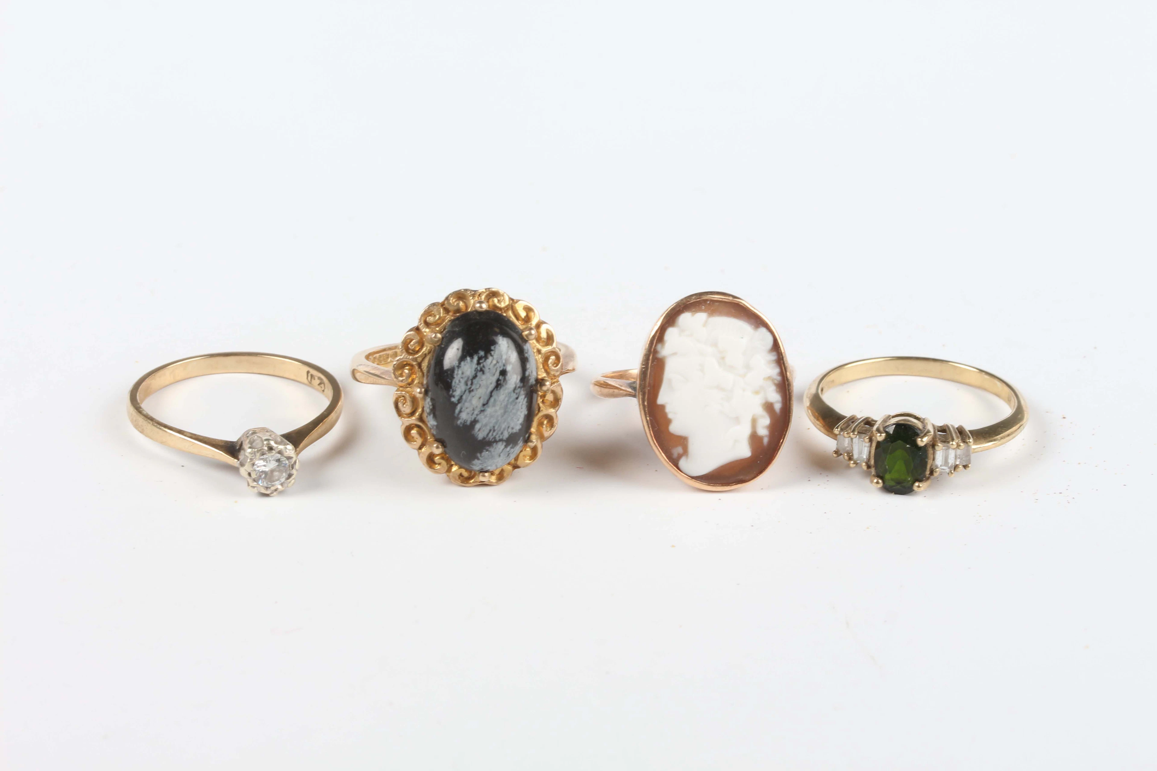 A 9ct gold, green tourmaline and diamond ring, claw set with an oval