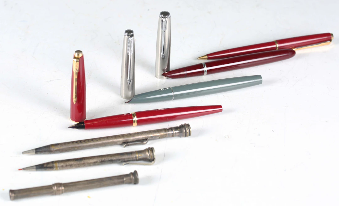 Three Parker fountain pens, a Parker propelling pencil, two silver