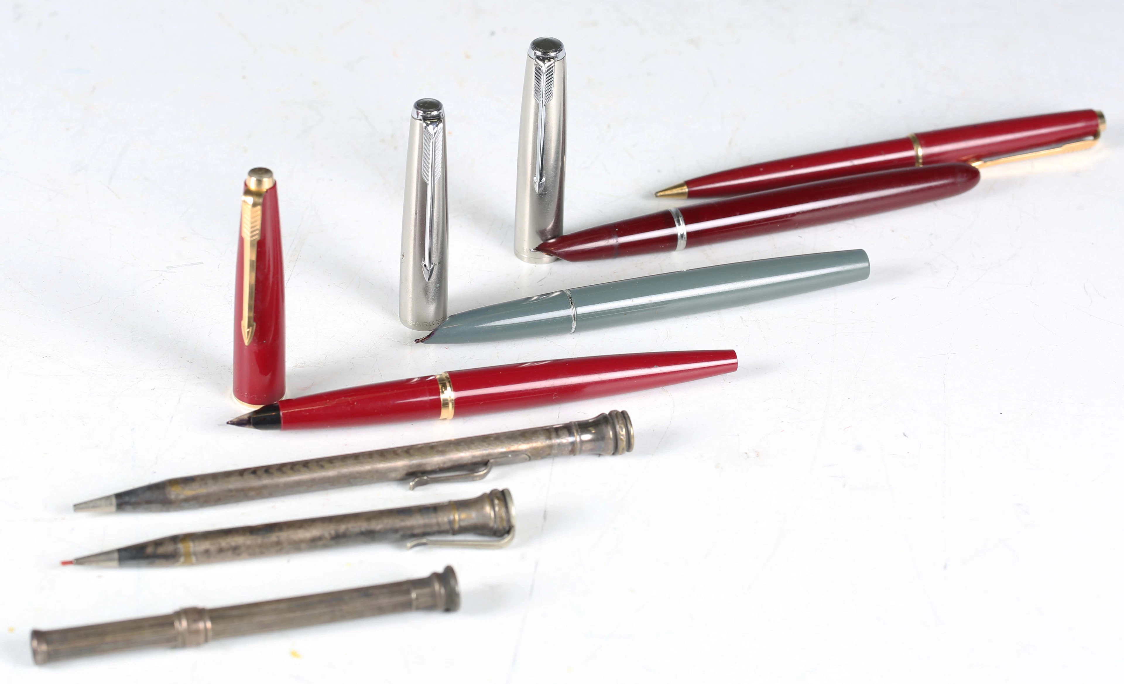 Three Parker fountain pens, a Parker propelling pencil, two silver