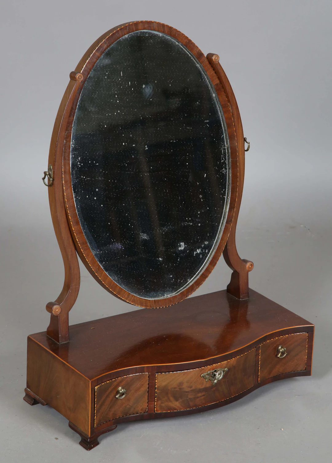 A late George III mahogany swing frame dressing table mirror, the