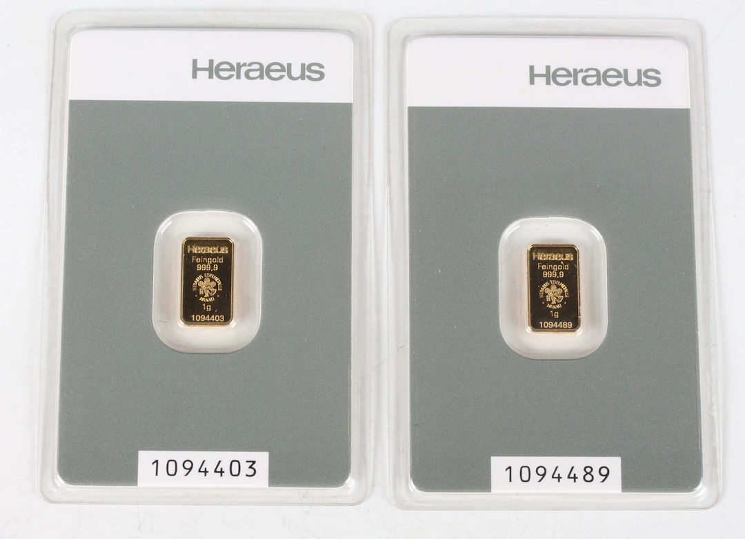 Two Switzerland Heraeus gold one gram ingots, each within a soft slab