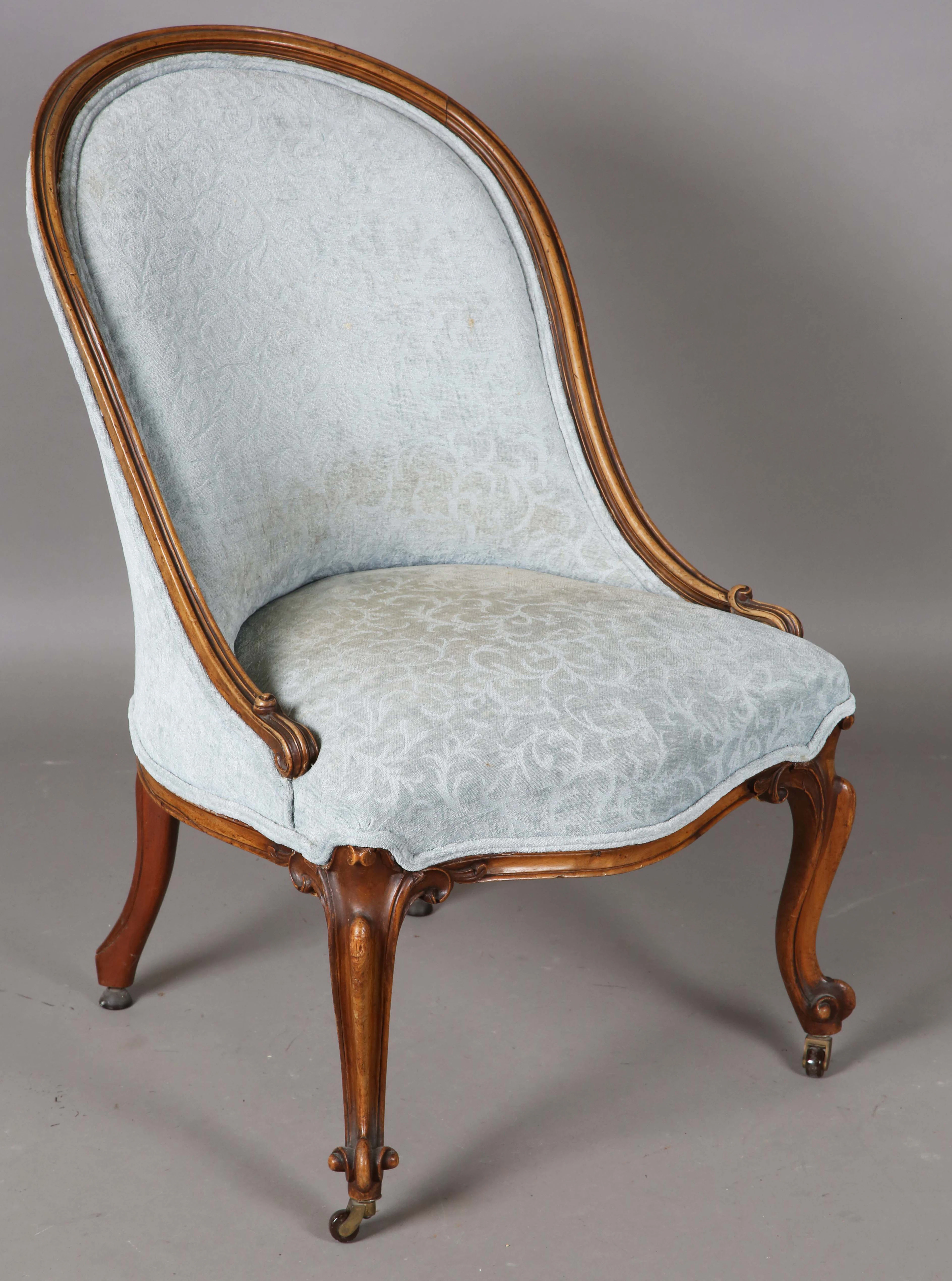 A mid-Victorian walnut showframe salon chair, raised on carved cabriole