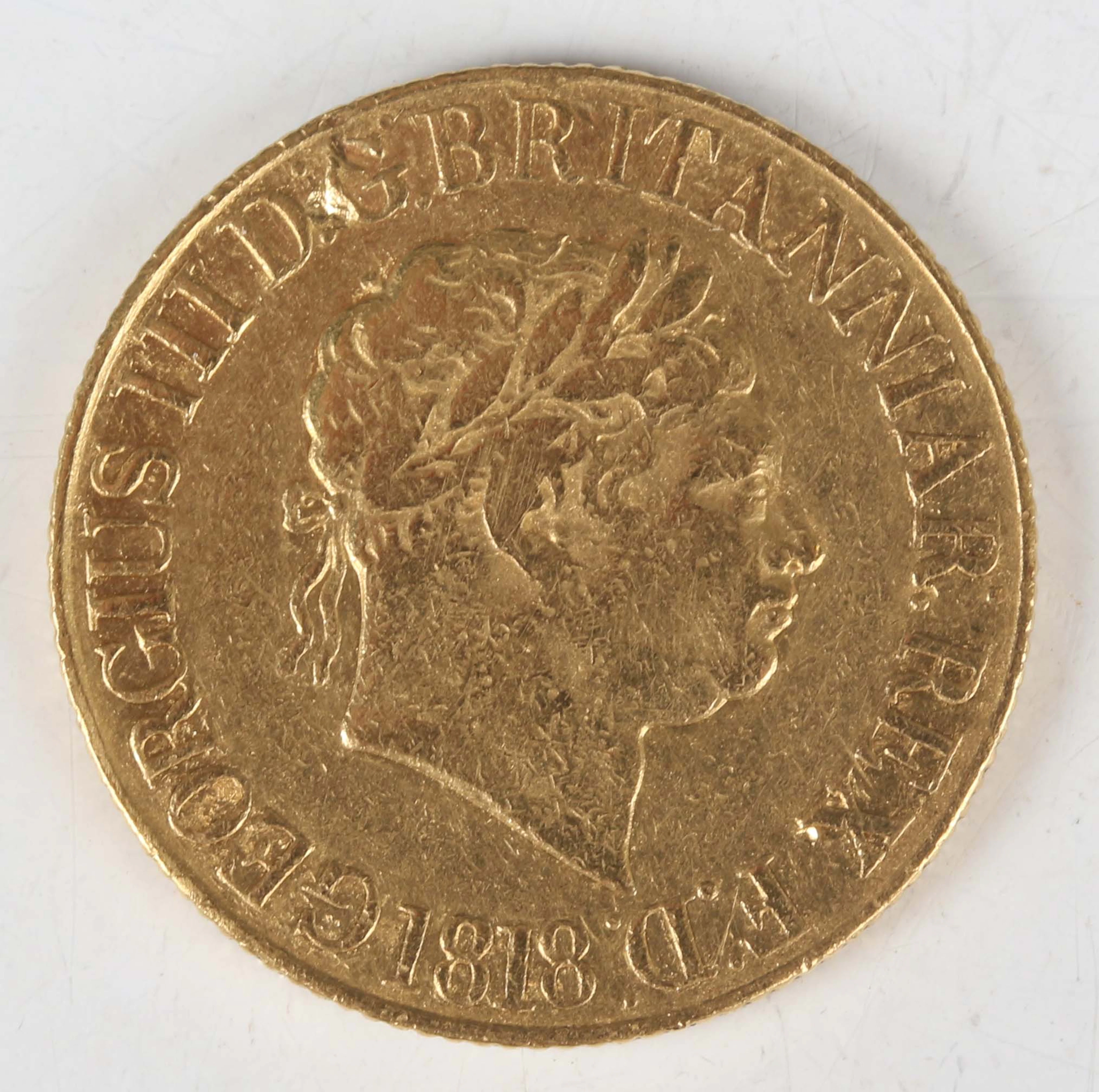 A George III sovereign 1818, Sp 3785 (fair/fine, some gouges and misshaping