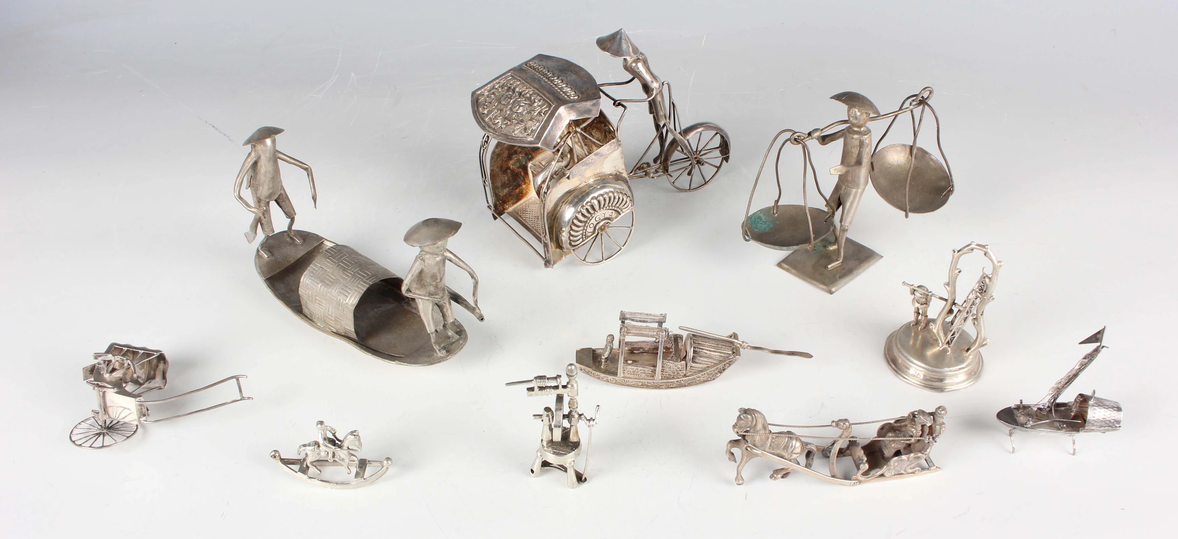 A small group of seven miniature toy silver items, including a 20th
