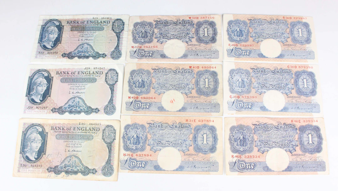 A large collection of British banknotes, including twenty pounds