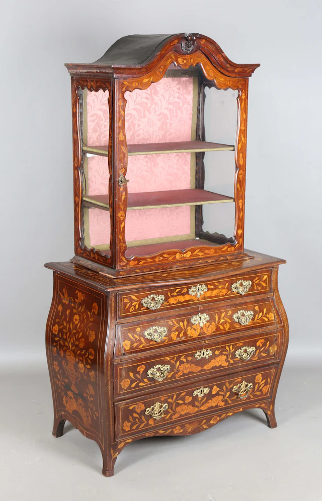 A 19th century Dutch floral marquetry bombé bookcase chest, the glazed