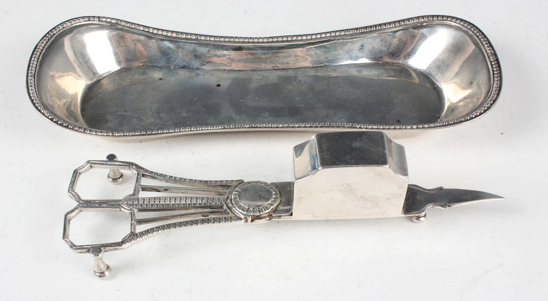 A pair of George III silver candle snuffers with gadrooned handles