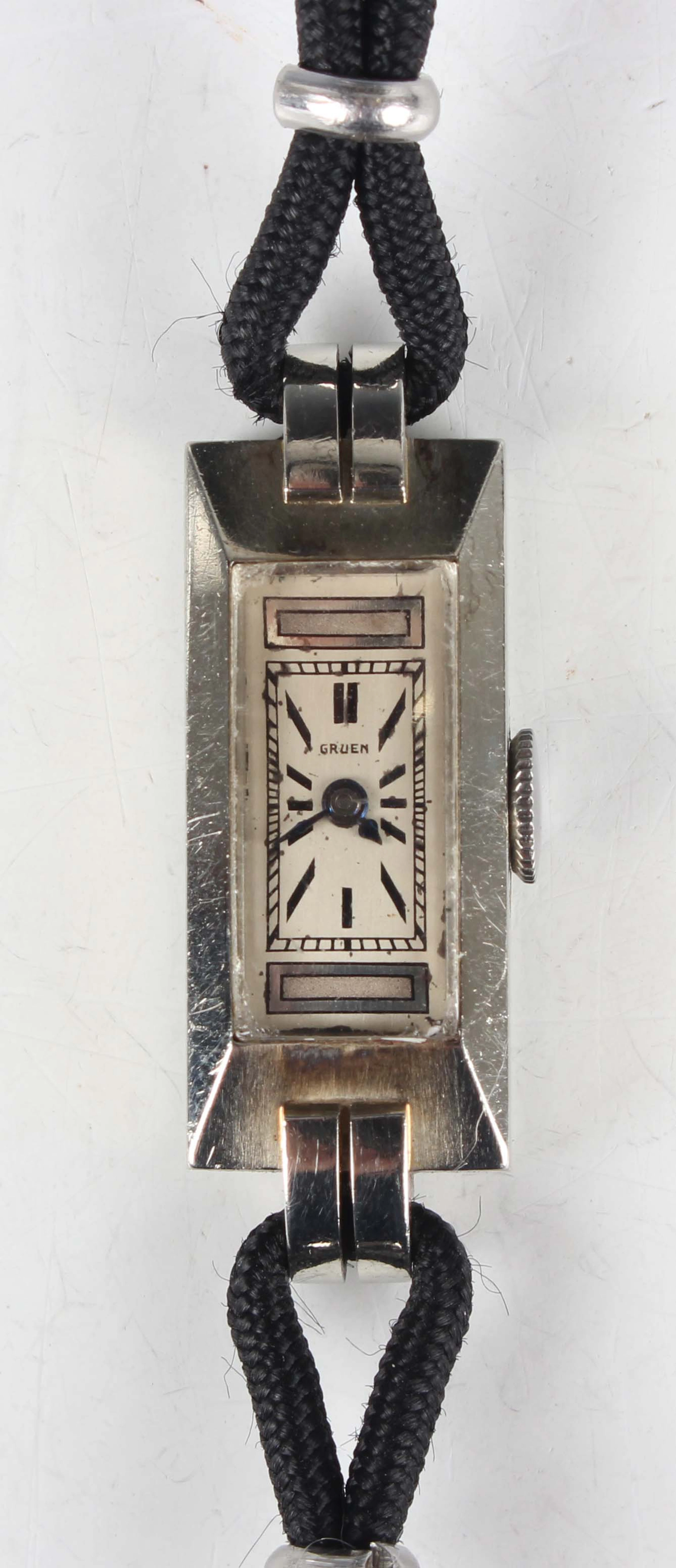 A Gruen white gold rectangular cased lady's wristwatch, the jewelled