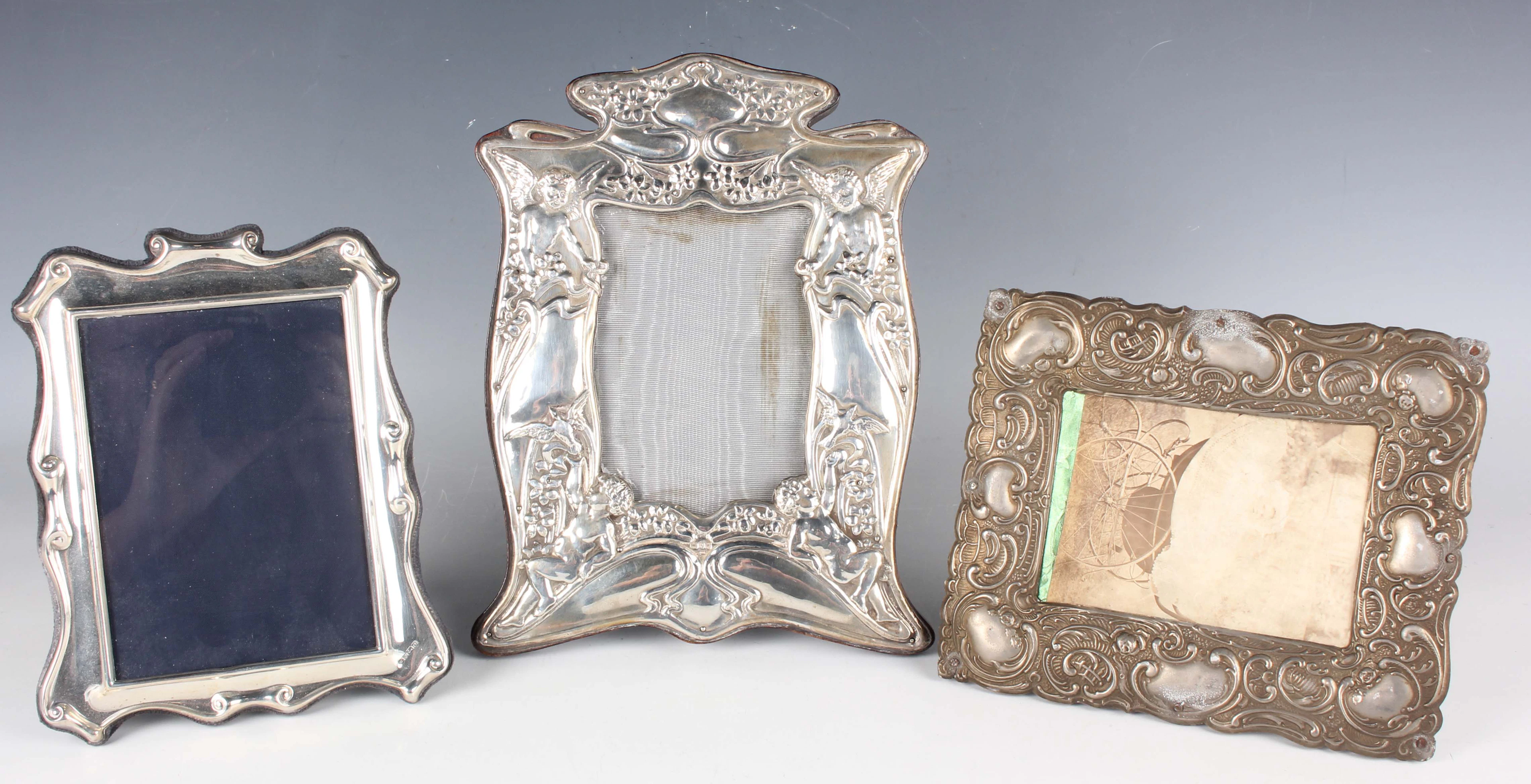 An Art Nouveau silver mounted photograph frame, embossed with a pair