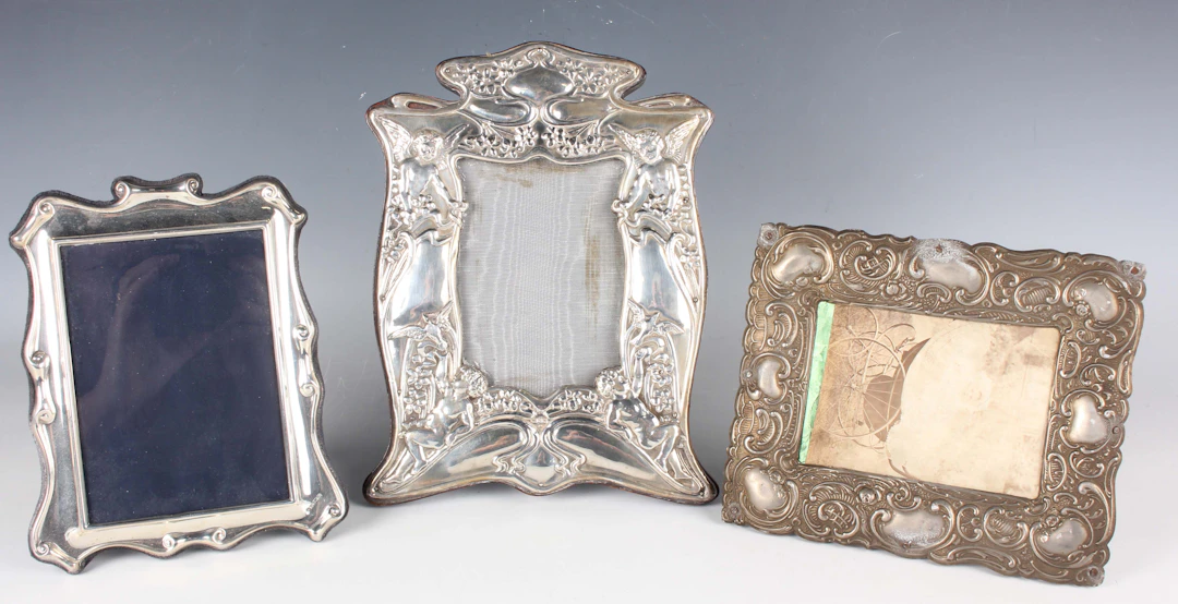 An Art Nouveau silver mounted photograph frame, embossed with a pair