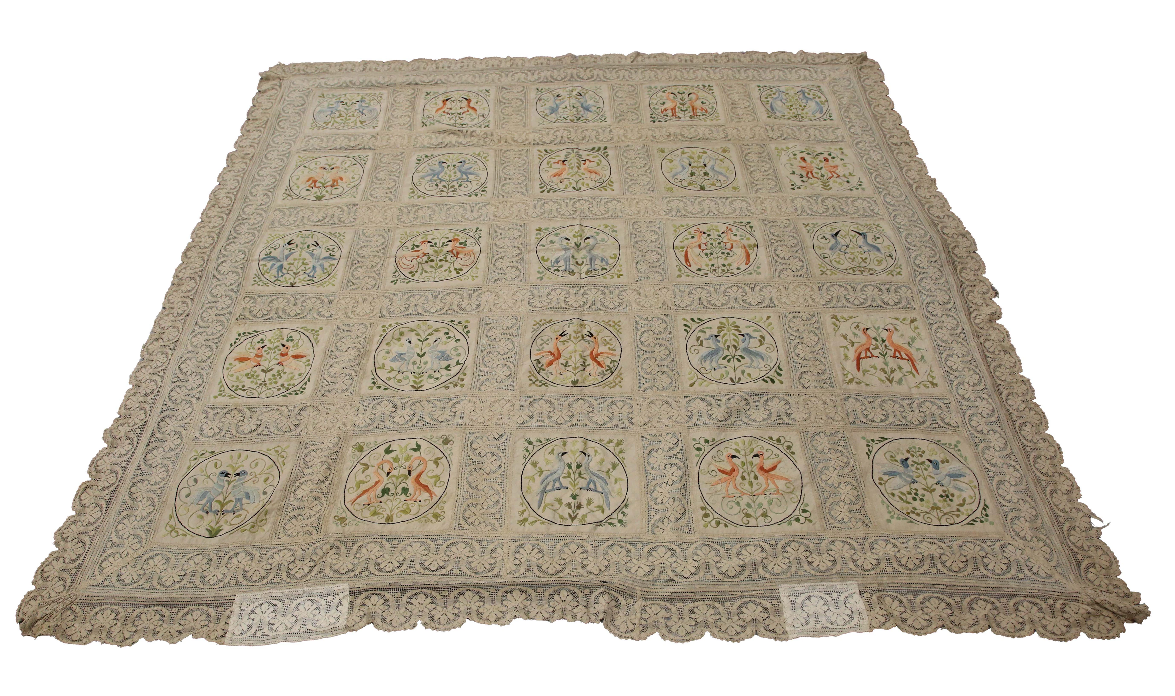 An early 20th century Arts and Crafts lace and silk embroidered bedcover