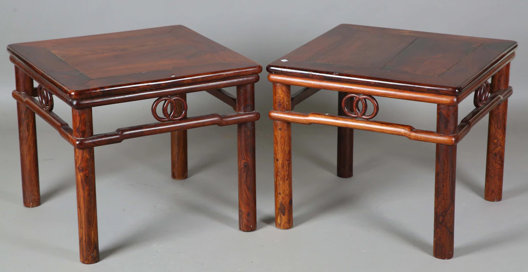 A pair of 20th century Chinese rosewood square tables with carved