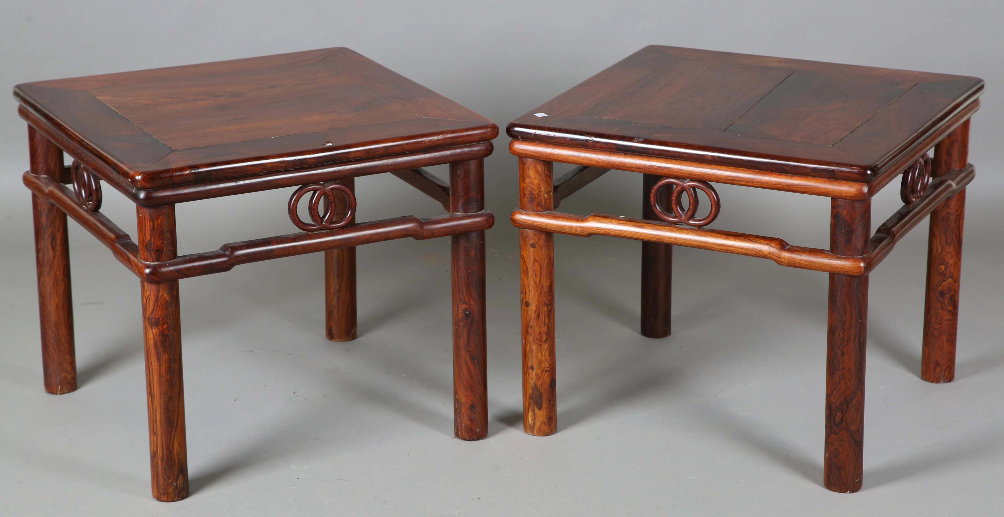 A pair of 20th century Chinese rosewood square tables with carved