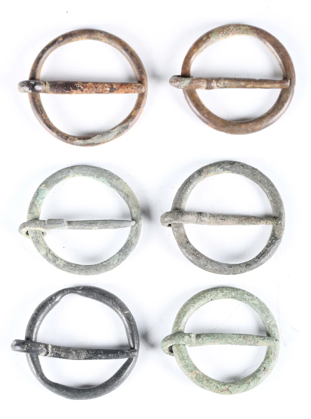 A group of six medieval copper alloy annular brooches of typical circular