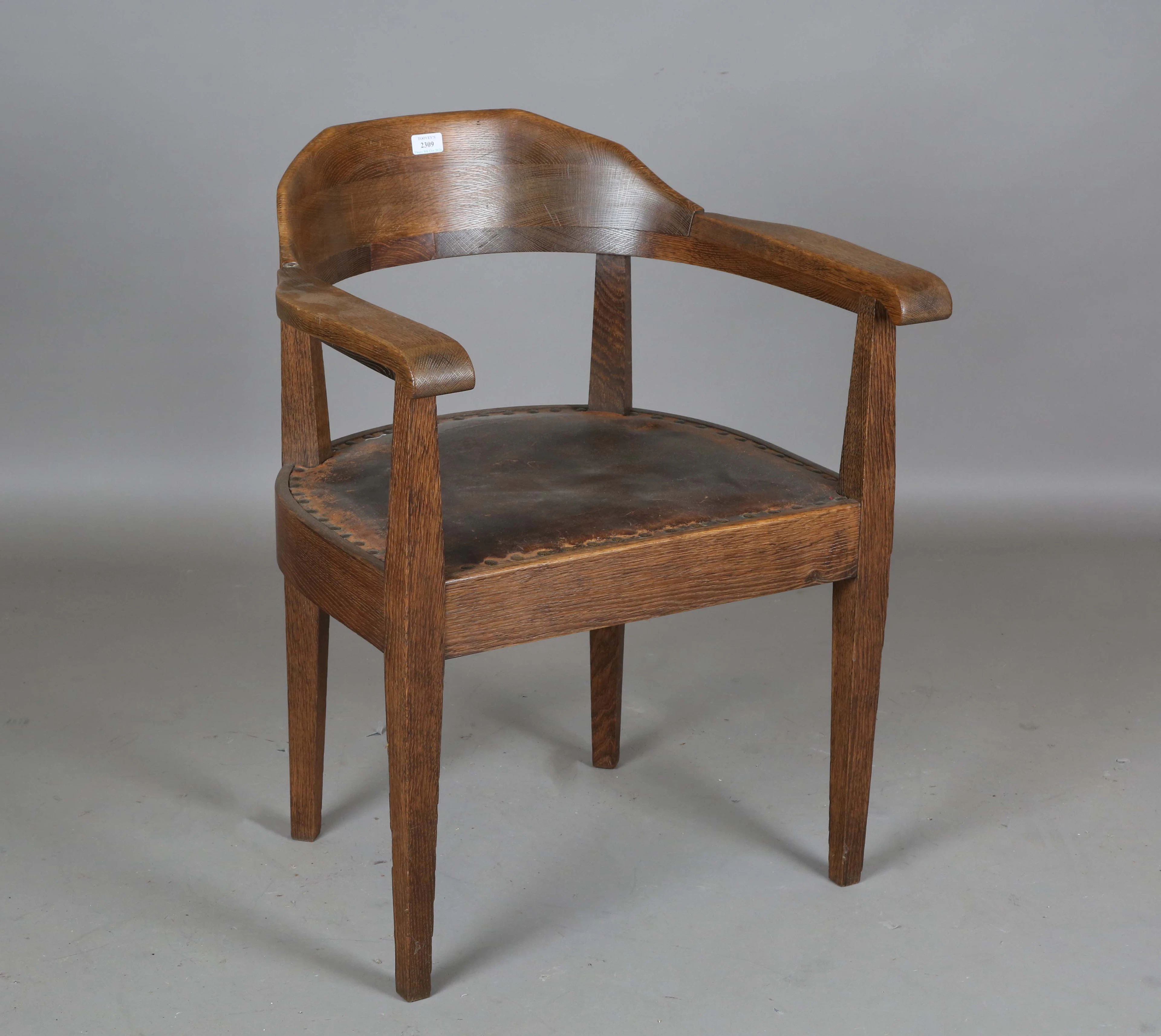 An Edwardian Arts and Crafts oak framed tub back elbow chair, possibly