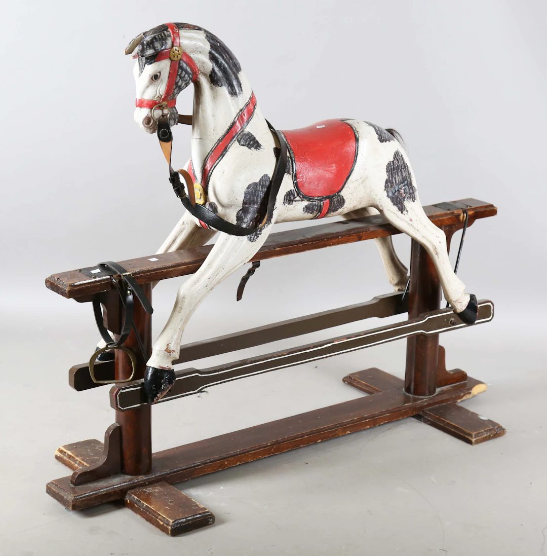 A 20th century carved and painted wooden rocking horse, raised on