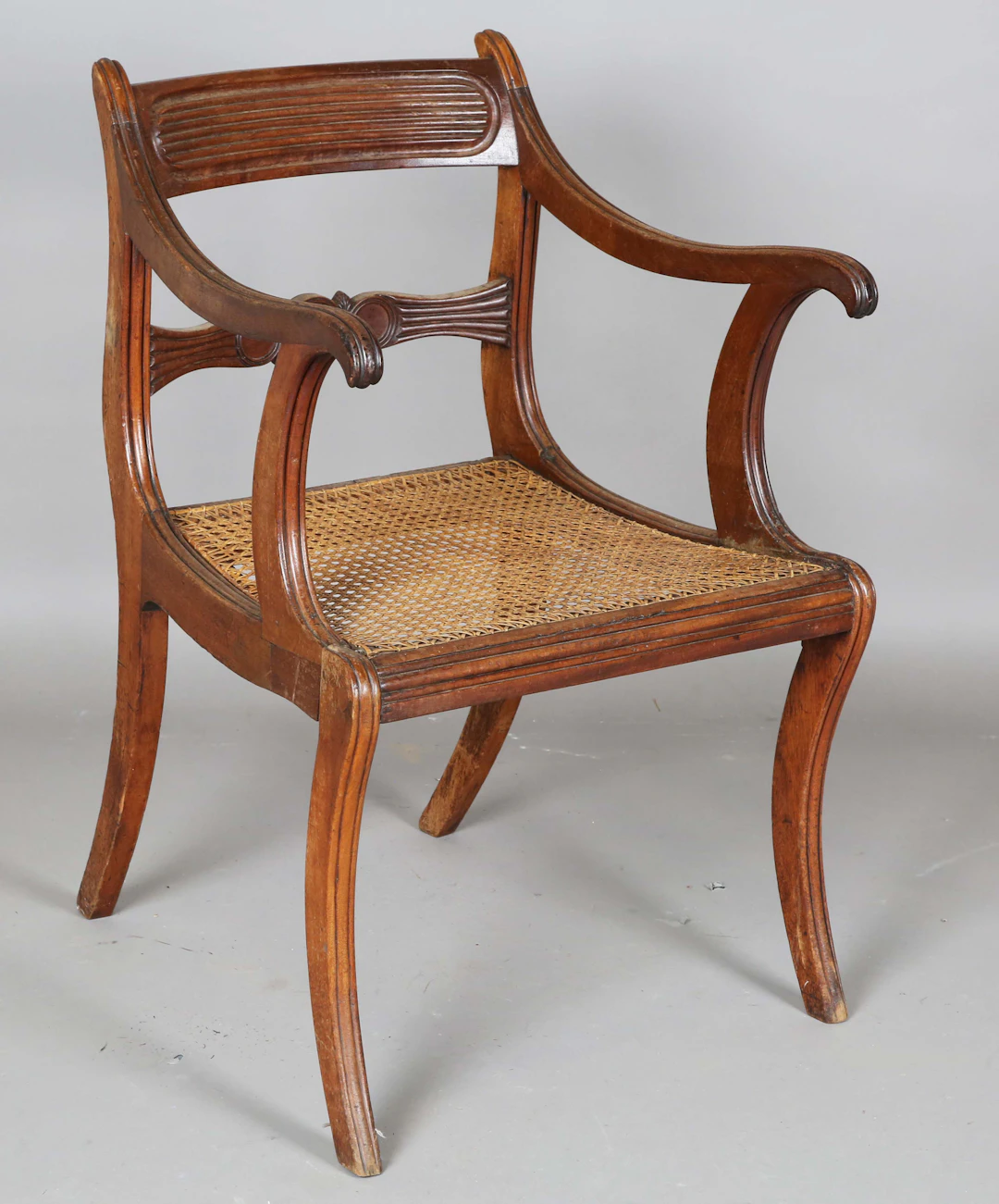 A Regency mahogany bar back elbow chair with a caned seat, height