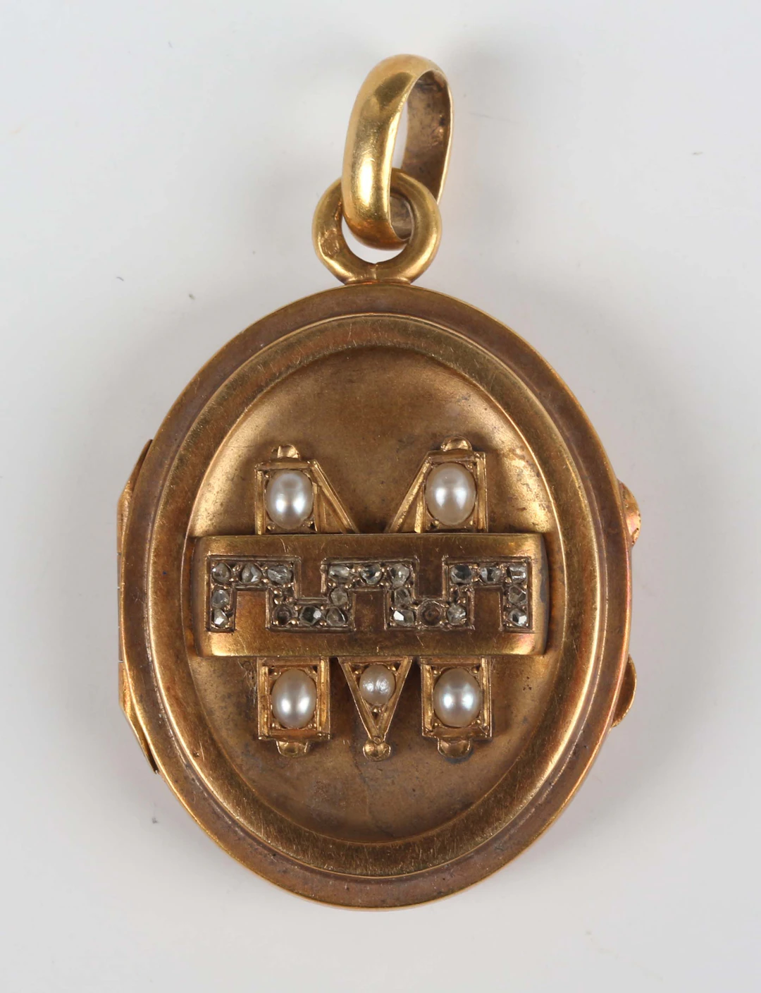 A French gold, rose diamond and half-pearl set oval pendant locket