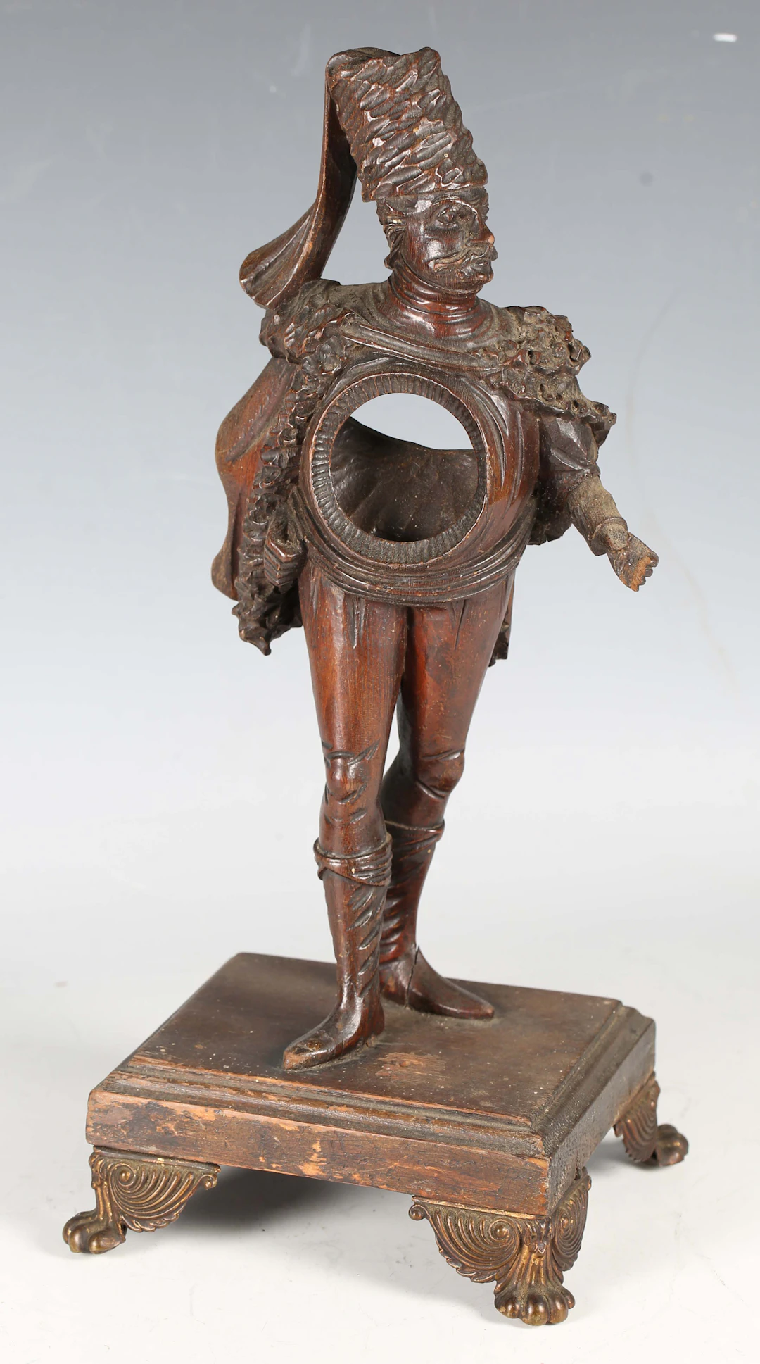 A 19th century Continental carved softwood figural pocket watch holder