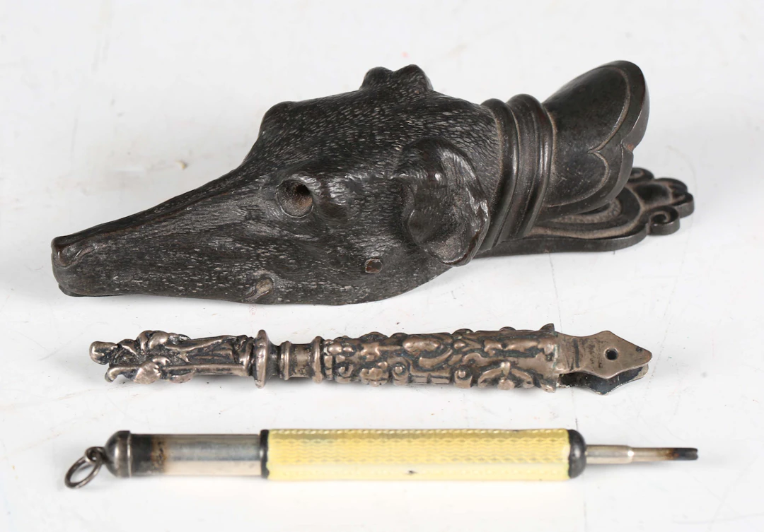 A 19th century cast bronze paperclip in the form of the head of a