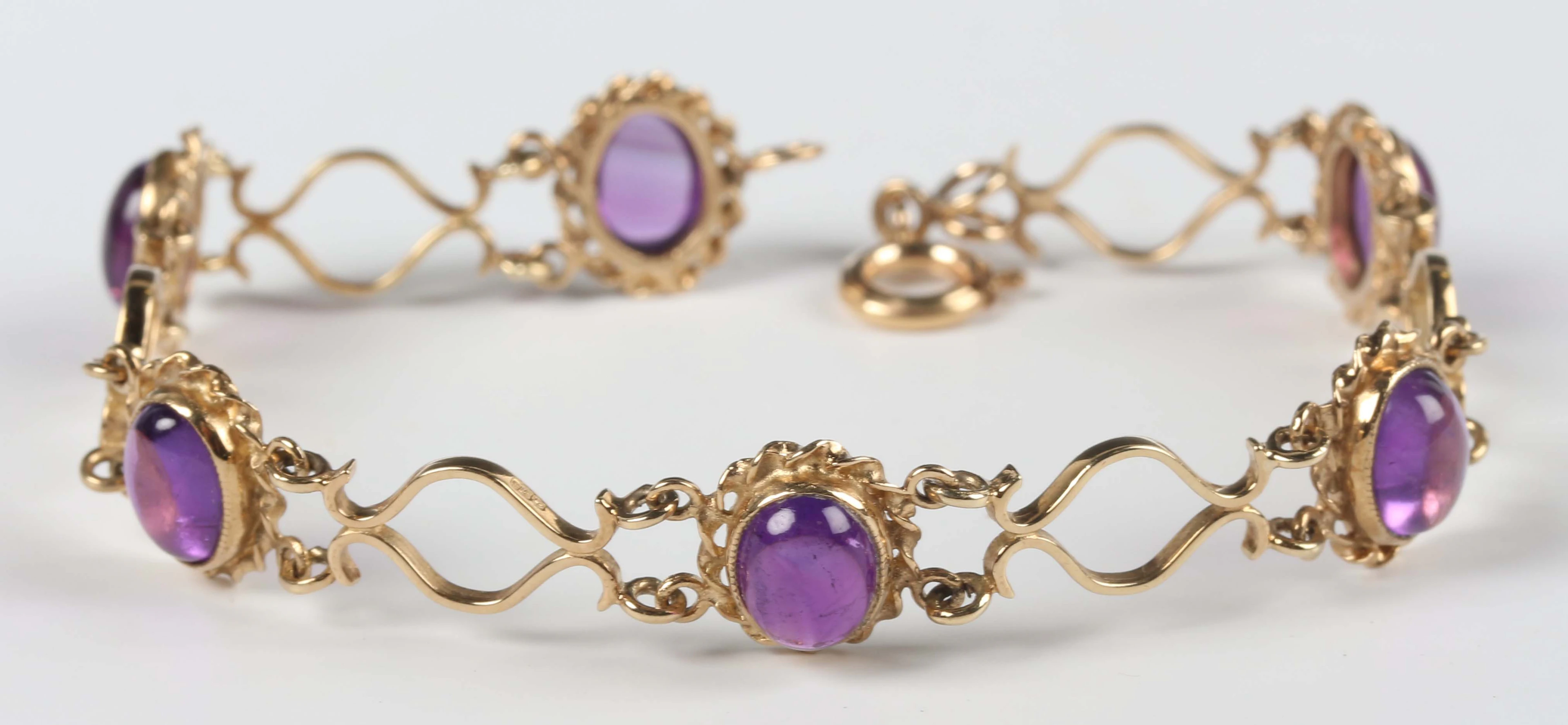 A 9ct gold and amethyst bracelet, mounted with a row of six oval cabochon