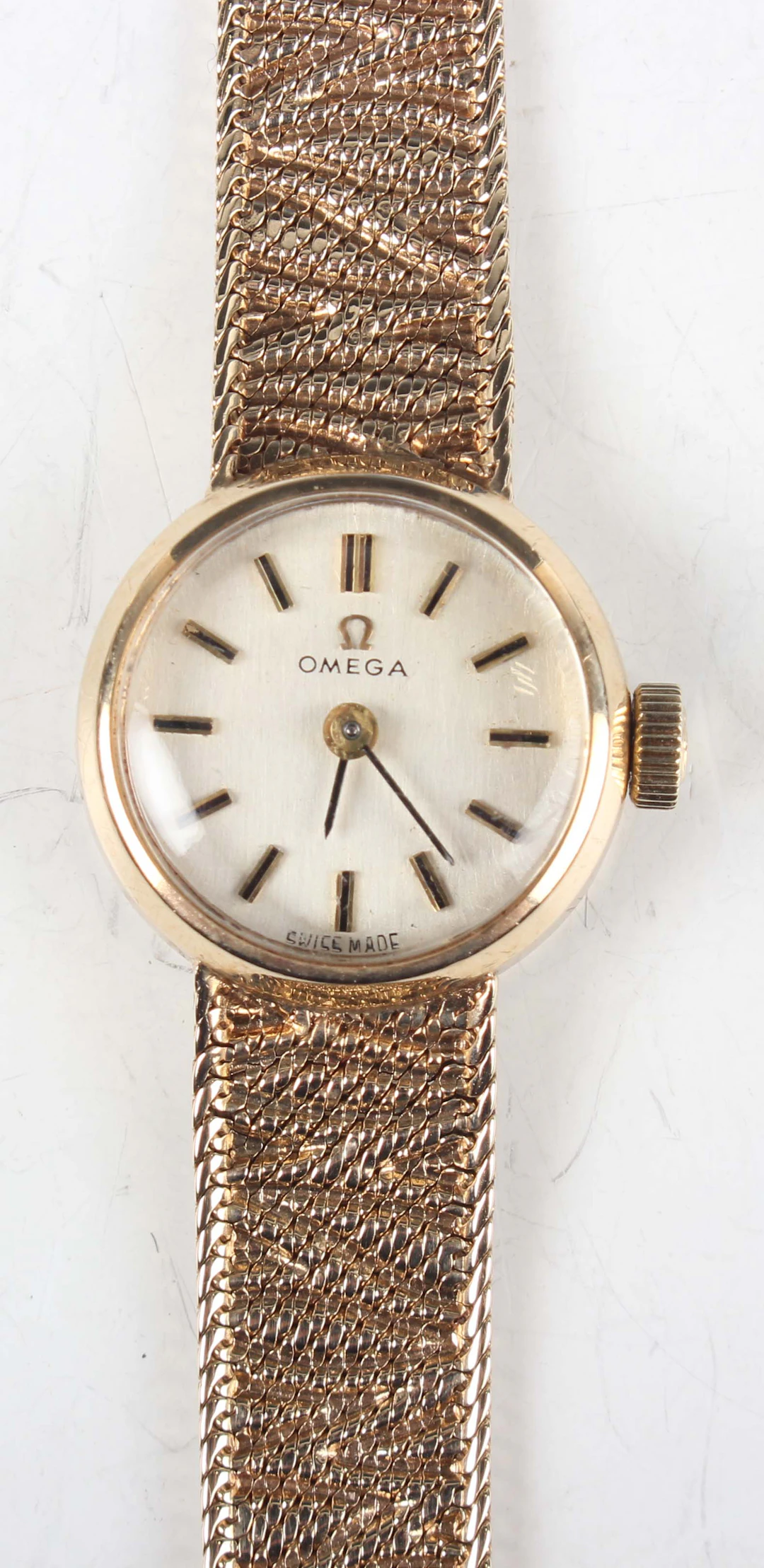 An Omega 9ct gold circular cased lady's bracelet wristwatch with signed