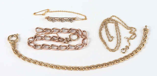 A 9ct gold curb and twist link bracelet on a boltring clasp, length