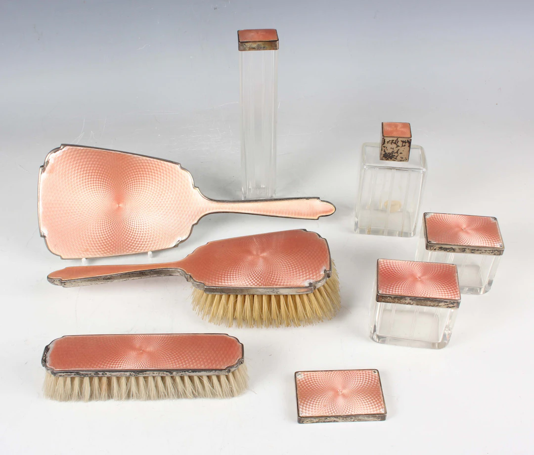 A George V silver and peach enamelled dressing table set, comprising