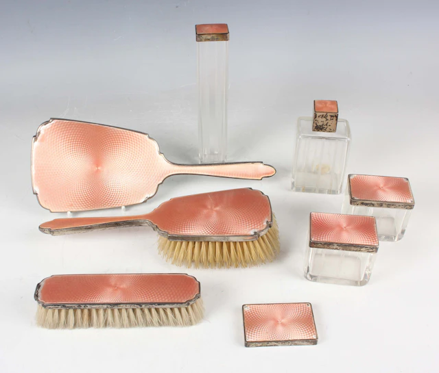 A George V silver and peach enamelled dressing table set, comprising