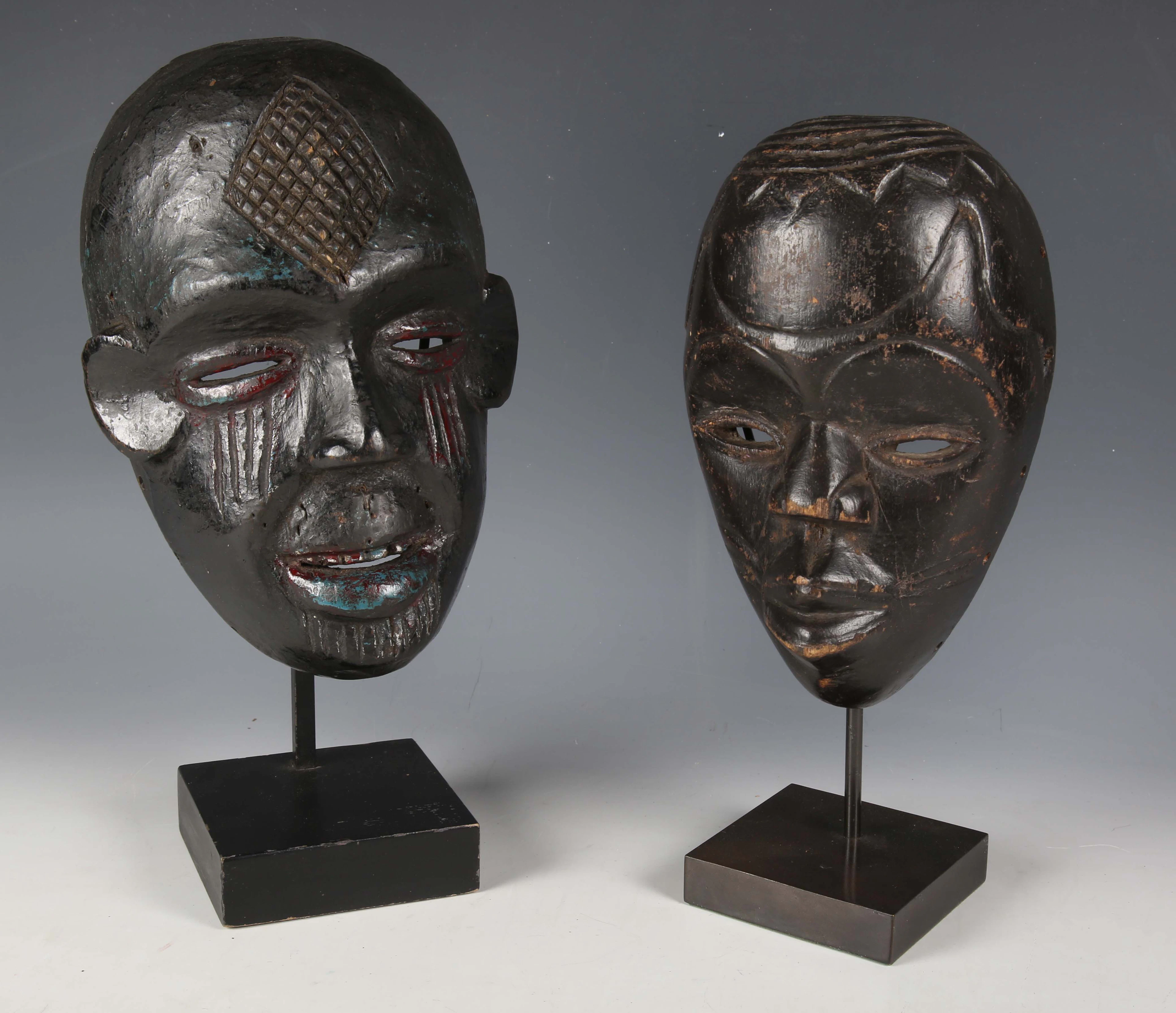 An Ibibio carved wooden mask, Nigeria, the darkly patinated surface