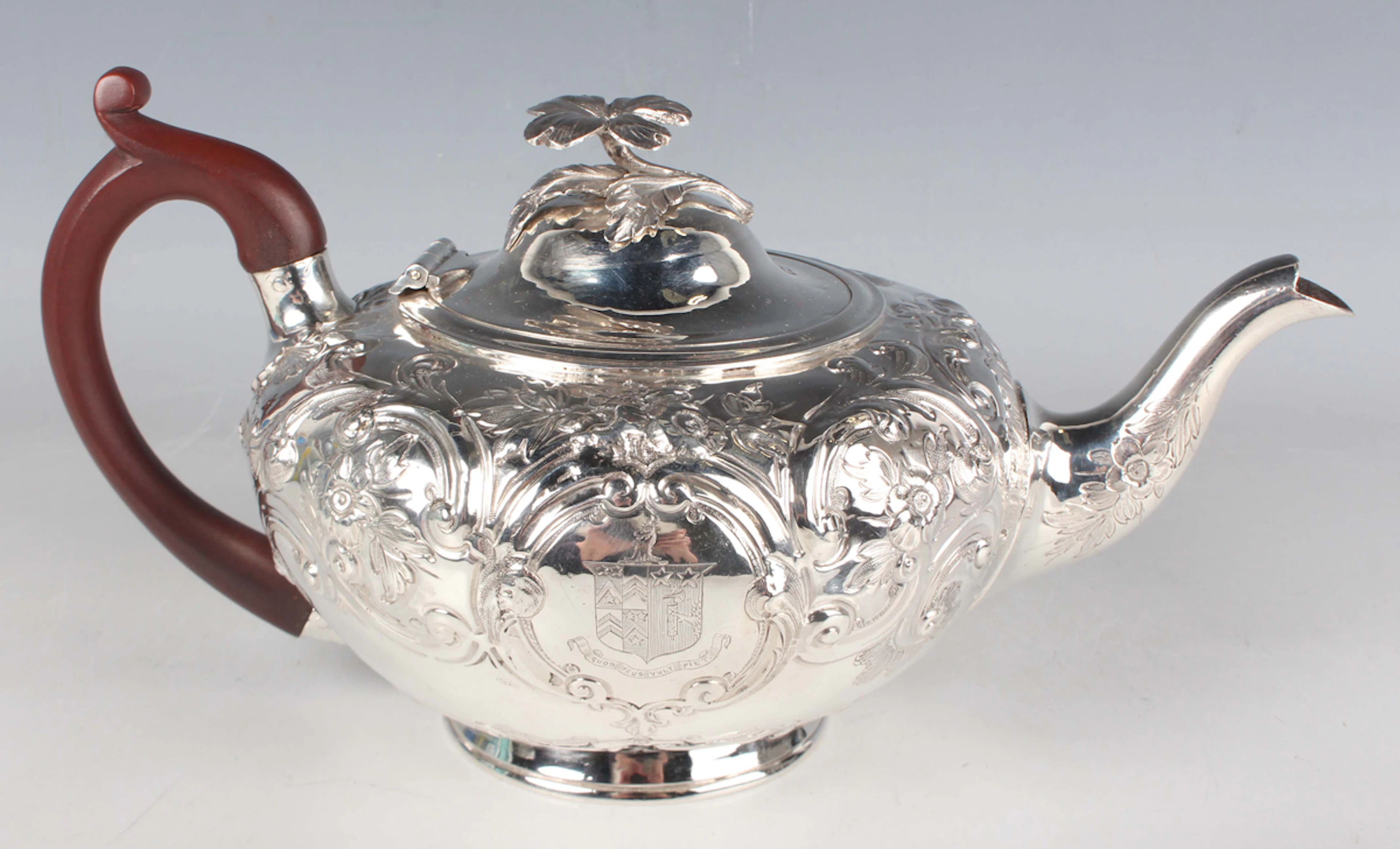 A George III silver teapot of squat circular form, the hinged lid