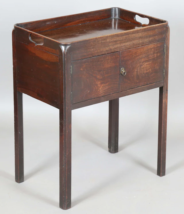 A George III mahogany night cupboard, the galleried top above a pair