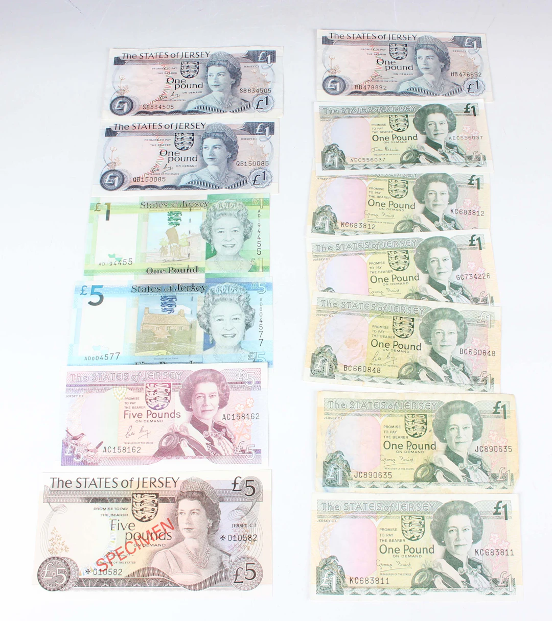 A small collection of Jersey and Guernsey banknotes, including an
