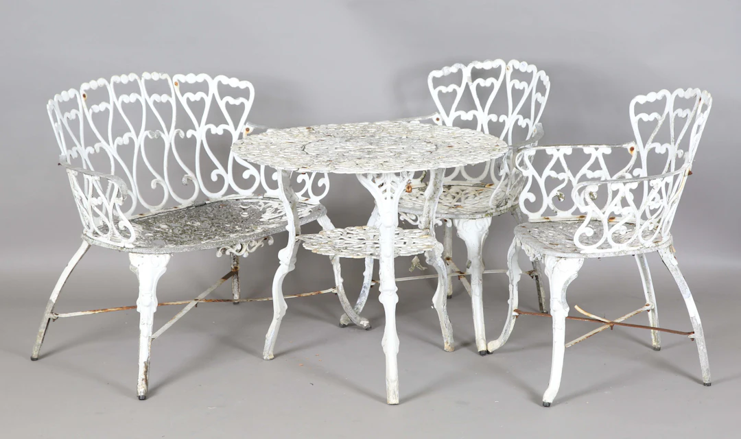 A 20th century white painted cast alloy garden suite, comprising a