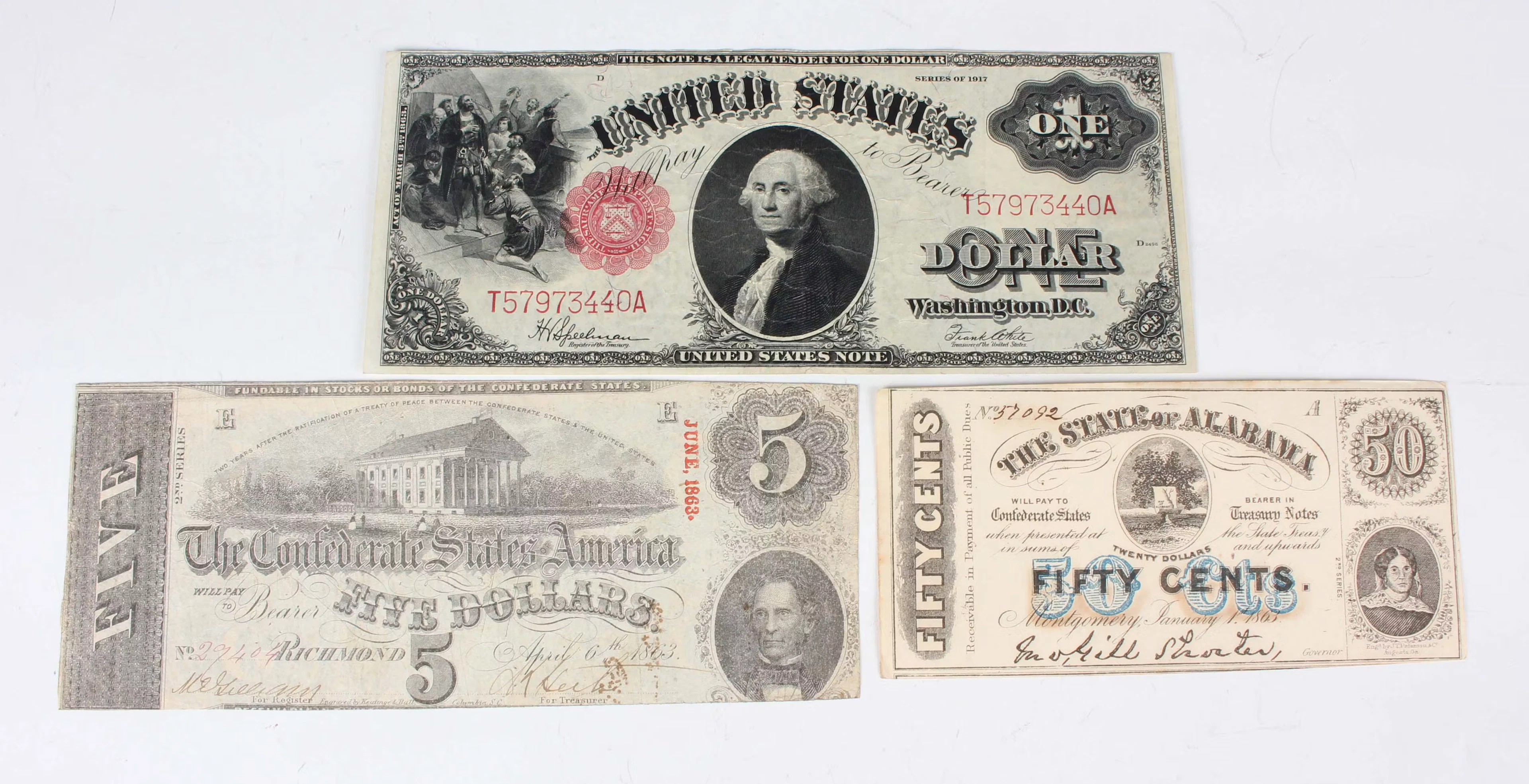 A small group of USA banknotes, including a United States one dollar
