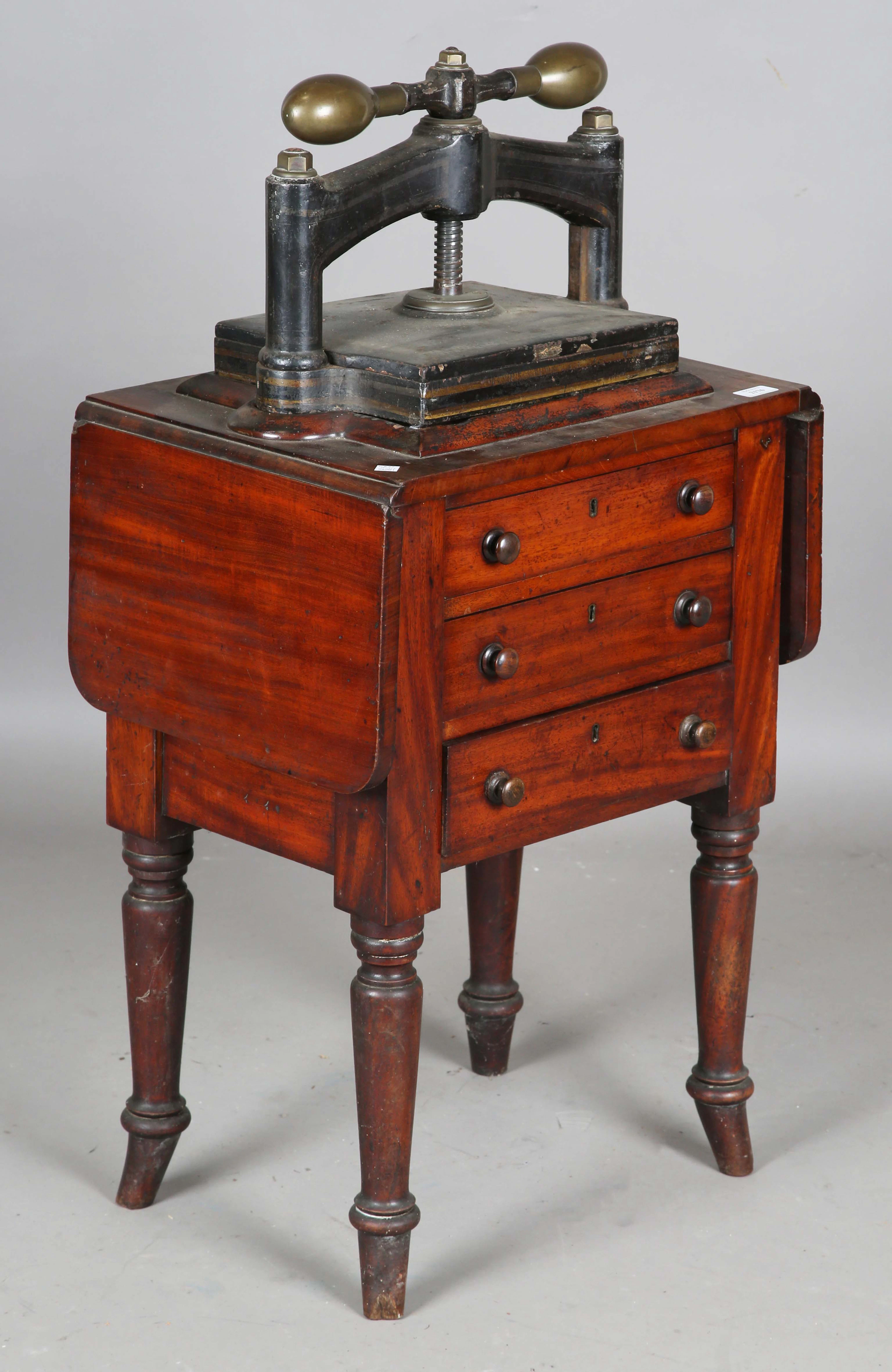 A Victorian mahogany and cast iron book press table, fitted with two