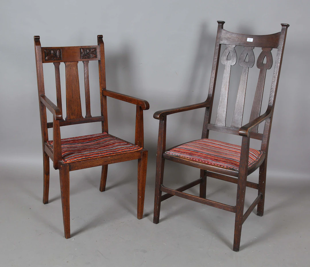 An Edwardian Arts and Crafts oak framed elbow chair, in the manner